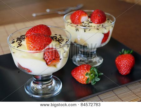 Dessert vanilla pudding with fresh strawberries