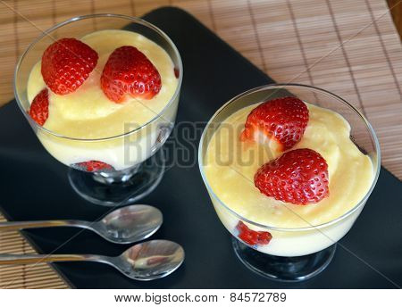 Dessert vanilla pudding with fresh strawberries