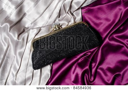 Black Clutch On A Silk Background
