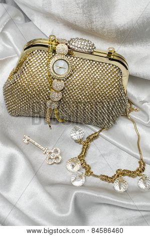 Set Of Women's Accessories On A White Silk Background
