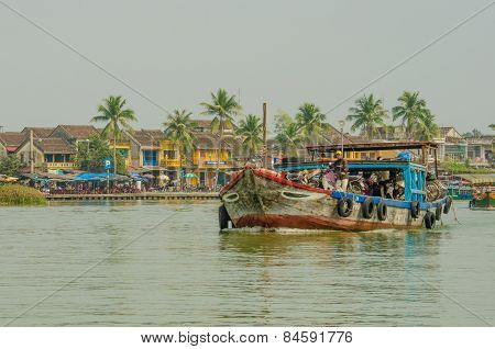 Crowded ferry transports people along the Thu Bòn River in Vietnam