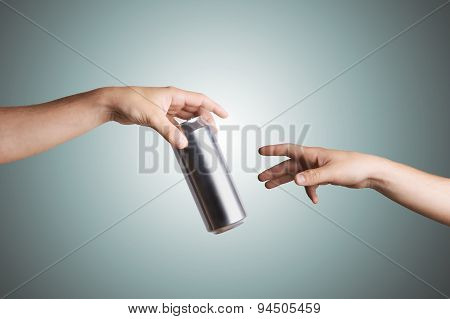 Male hand giving a beer can to another person
