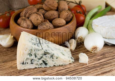 Portion Of Niva Danish Blue Cheese Next To Various Vegetable