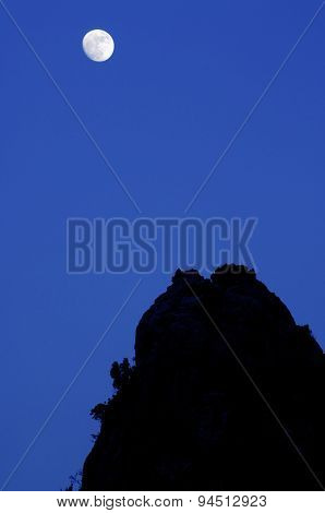 Moon and  rocky pinnacles in  Maestrazgo Mountains, Teruel, Aragon, Spain