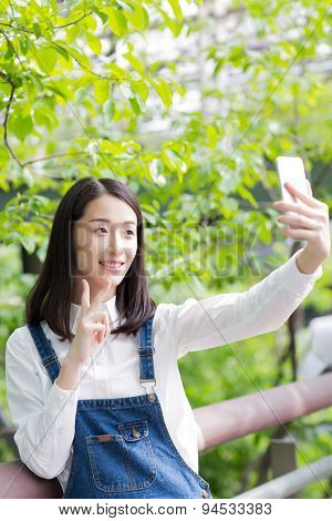 Girl With A Cell Phone Self-timer