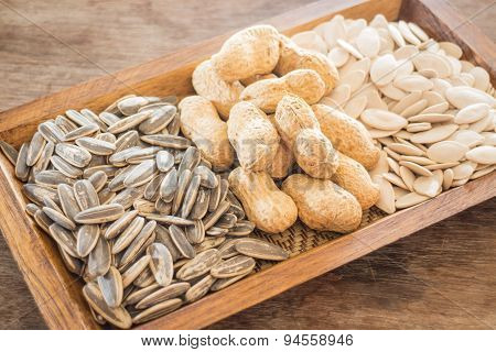 Assorted Of Whole Grain Sunflower, Peanut And Pumpkin On Wooden Table
