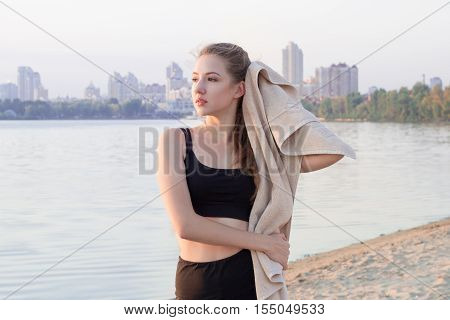 Young Pretty Slim Fitness Sporty Woman Rests And Wipes Herself With Towel During Training Workout Ex