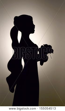 silhouette of a young bride, with bouquet