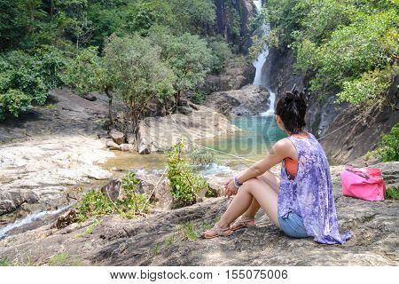 Women tourist watching the waterfall on Koh Chang or Chang island Thailand