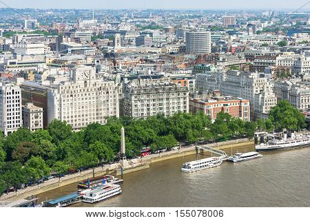 London panorama with Victoria Embankment on river Thames with Cleopatra's Needle and urban architectures. United Kingdom