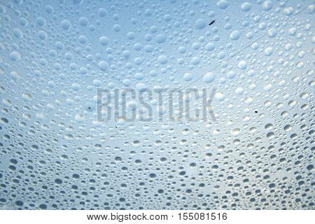 mist droplets lined up in front of a blue background