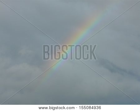 faint rainbow appeared in the sky before the clouds