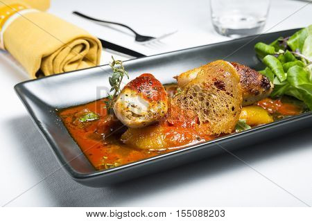 Spicy roast squid serve with bread on dining table
