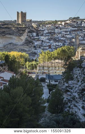 Alcala del Jucar Spain - October 29 2016: Side view of the village on top of limestone mountain is situated Castle of the 12TH century Almohad origin take in Alcala of the Jucar Albacete province Spain