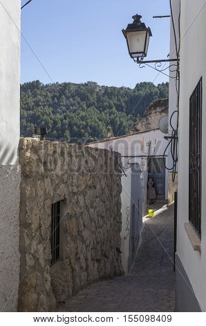 Alcala del Jucar Spain - October 29 2016: Narrow street with white painted houses typical of this town take in Alcala of the Jucar Albacete province Spain