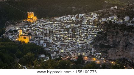 Alcala del Jucar Spain - October 29 2016: Night view of the city on top of limestone mountain is situated Castle of the 12TH century Almohad origin take in Alcala of the Jucar Albacete province Spain