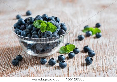 Blueberries in glass bowls rustic style wooden background