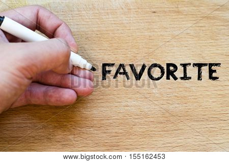 Human hand over wooden background and favorite text concept