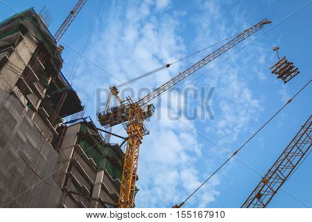 Crane in a construction site with blue sky background