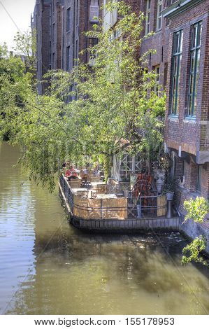 GHENT BELGIUM - May 02.2011: Visitors to the little homemade cafe on city canal
