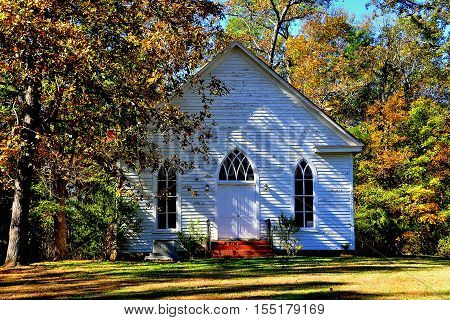 Farriington North Carolina - November 5 2016: Circa 1900 O'Kelly Chapel Christian Church white clapboard gothic revival one room rural chapel with lancet windows