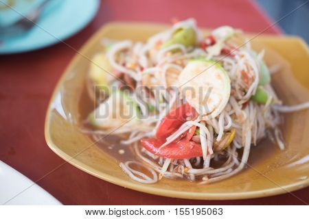 Tum Sua Papaya Salad with Vermicelli Salted Crab and Fermented Fish Traditional Thai Food selective focus