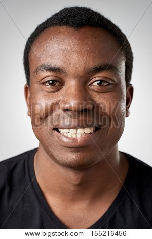 Happy smiling african black man portrait of real person in studio. full collection of diverse faces in this set.