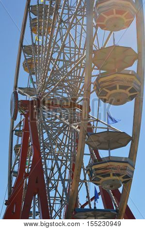 vertical Ferris wheel underside passenger car sky blue