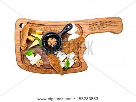 Top view Cheese plate served parmesan, mozzarella, dorblu, nuts, honey and bread slices on on wooden chopping board isolated. Assortment of various appetizers, tasty food concept.