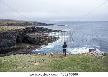 Girl looking Panorama of Orkney coastline Yesnaby cliff landscape 2