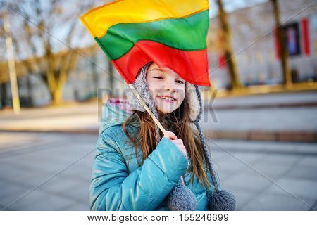 Cute Little Girl Holding Lithuanian Flags In Vilnius