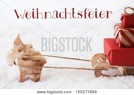 German Text Weihnachtsfeier Means Christmas Party. Moose Is Drawing A Sled With Red Gifts Or Presents In Snow. Christmas Card For Seasons Greetings.