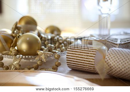 Dining table draped in golden Christmas decor