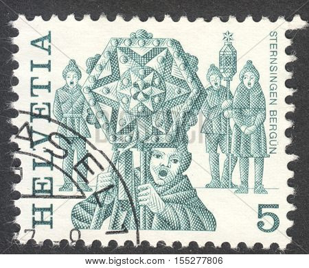 MOSCOW RUSSIA - CIRCA OCTOBER 2016: a stamp printed in SWITZERLAND shows traditional customs the series 