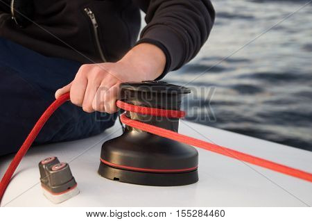 Winch with rope on sailing boat in the sea