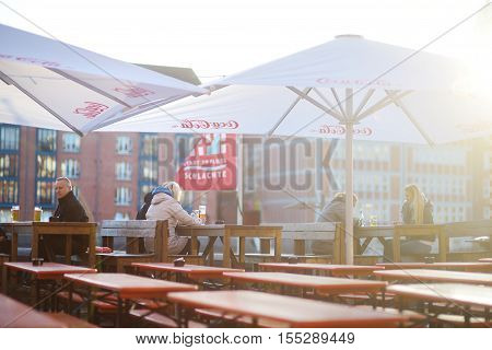 Bremen, Germany - March 23, 2016: Tourist Having A Beer In A Restaurant On An Embarktment Of Weser R