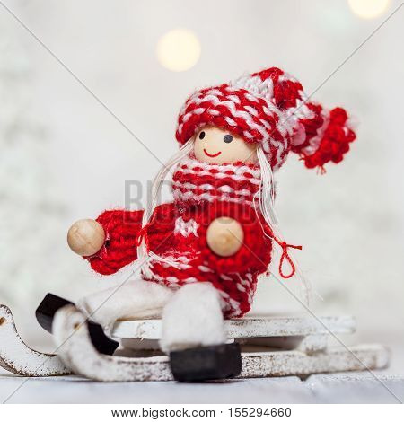 Christmas girl doll toy on a sleigh for decoration