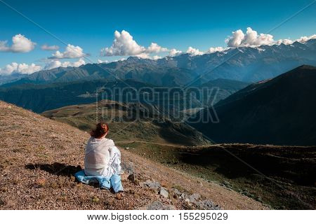 A woman traveling in the mountains, going ahead to the heights.