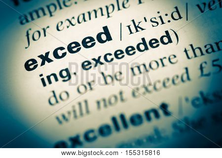Close Up Of Old English Dictionary Page With Word Exceed