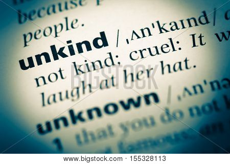 Close Up Of Old English Dictionary Page With Word Unkind
