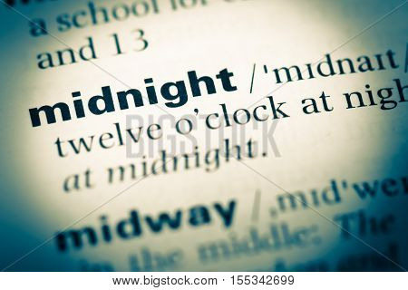 Close Up Of Old English Dictionary Page With Word Midnight