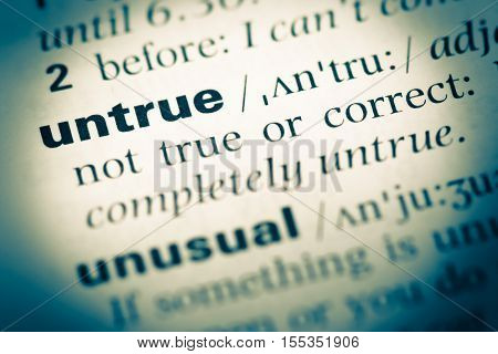 Close Up Of Old English Dictionary Page With Word Untrue