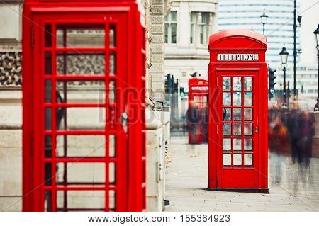 Crowd of people and red telephone boxes on the street in London The United Kingdom of Great Britain and Northern Ireland