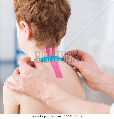Boy with cervical spine problem visiting physiotherapist