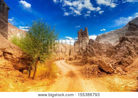Ruins and Basgo Monastery surrounded with stones and rocks Leh Ladakh Jammu and Kashmir India. Filtered image