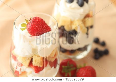 Small strawberry and blueberry trifles in glasses