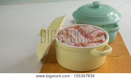 Ground pork wrapped in bacon and cooked in a pot