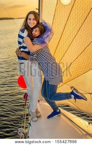 Holiday on a sailing yacht. Smiling girls on yacht. Living a happy life.
