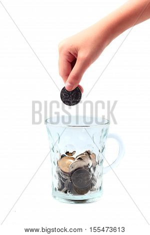 Financial education concept with child hands putting coins isolated on white background
