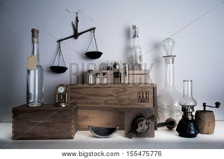 old pharmacy. bottles, jars, scales, a kerosene lamp on wooden shelves
